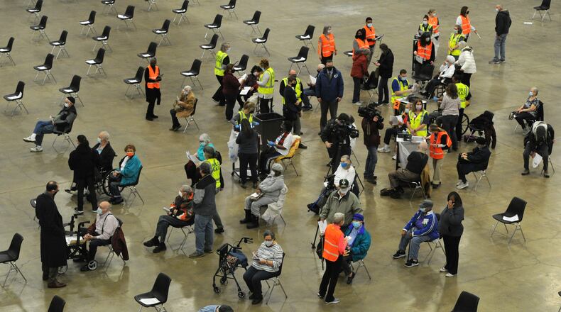 Hundreds of people arrived at the Dayton Convention Center Wednesday morning, Jan. 20, 2021, for the COVID-19 vaccination. MARSHALL GORBY\STAFF