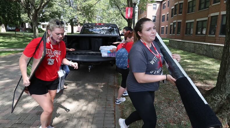 Wittenberg University has started disbursing over $2.2M in relief funds to students. Here, parents pulled their cars and trucks up to the dorm and upper classman helped freshman move their stuff into their rooms in August during Move-In Day at Wittenberg University. BILL LACKEY/STAFF
