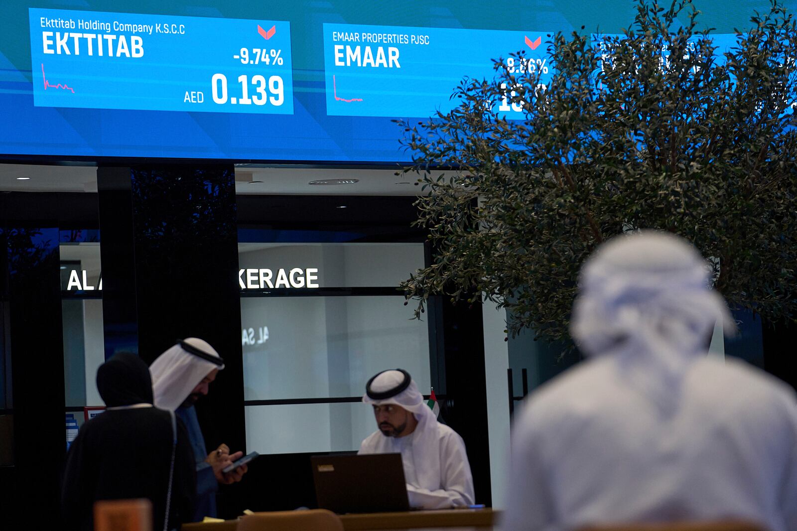 Emiratis are seen in the Dubai Financial Market in Dubai, United Arab Emirates, Monday, April 7, 2025. (AP Photos/Fatima Shbair)