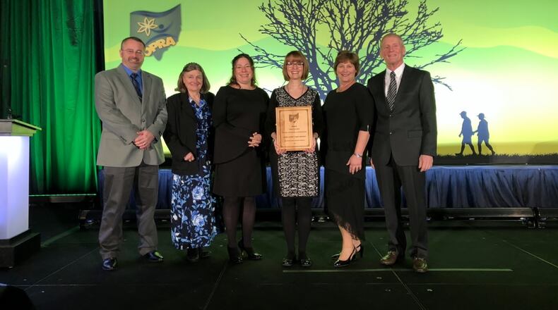 The Clark County Park District recently received a first-place award for the Mad River Gorge & Nature Preserve acquisition and clean-up in the Natural Resources & Conservation category at the Ohio Parks & Recreation Association Awards Banquet in Sandusky. Multiple members of the organization accepted the award, including (from left to right): , Chief Ranger/Operations Manager Chris Crowley, Office assistant Nancy Wallace, Program/Volunteer Coordinator Donna Lewis, Executive Director Carol Kennard, Park Commissioner Kim Fish and Park Commissioner Hal Goodrich. CONTRIBUTED PHOTO