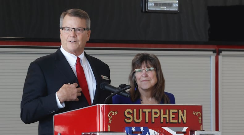 Drew Sutphen, president of Sutphen Corporation, and his cousin Julie Sutphen Phelps, vice president, speak during the grand opening of their new 185,000 square foot manufacturing facility in Urbana Tuesday, March 19, 2024. BILL LACKEY/STAFF