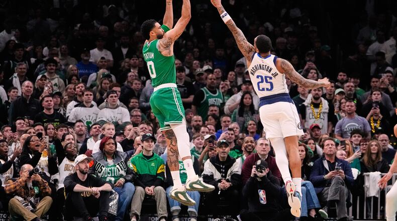 Boston Celtics forward Jayson Tatum (0) goes up to shoot over Dallas Mavericks forward P.J. Washington (25) during the first half of an NBA basketball game, Friday, March 6, 2026, in Boston. (AP Photo/Charles Krupa)
