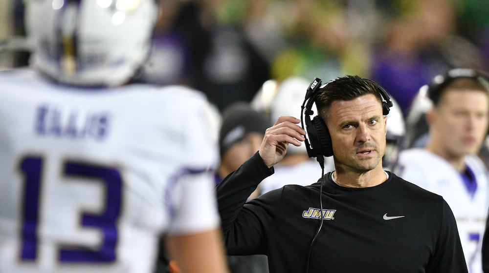 James Madison head coach Bob Chesney talks to wide receiver Landon Ellis (13) after a pass play against Oregon during the first half in the first round of the NCAA College Football Playoff, Saturday, Dec. 20, 2025, in Eugene, Ore. (AP Photo/Mark Ylen)