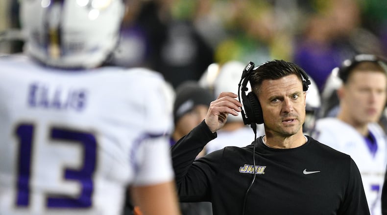 James Madison head coach Bob Chesney talks to wide receiver Landon Ellis (13) after a pass play against Oregon during the first half in the first round of the NCAA College Football Playoff, Saturday, Dec. 20, 2025, in Eugene, Ore. (AP Photo/Mark Ylen)