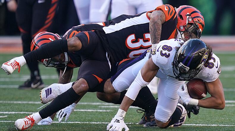 CINCINNATI, OHIO - NOVEMBER 10: Willie Snead #83 of the Baltimore Ravens is tackled by Jessie Bates #30 of the Cincinnati Bengals during the NFL football game at Paul Brown Stadium on November 10, 2019 in Cincinnati, Ohio. (Photo by Bryan Woolston/Getty Images)