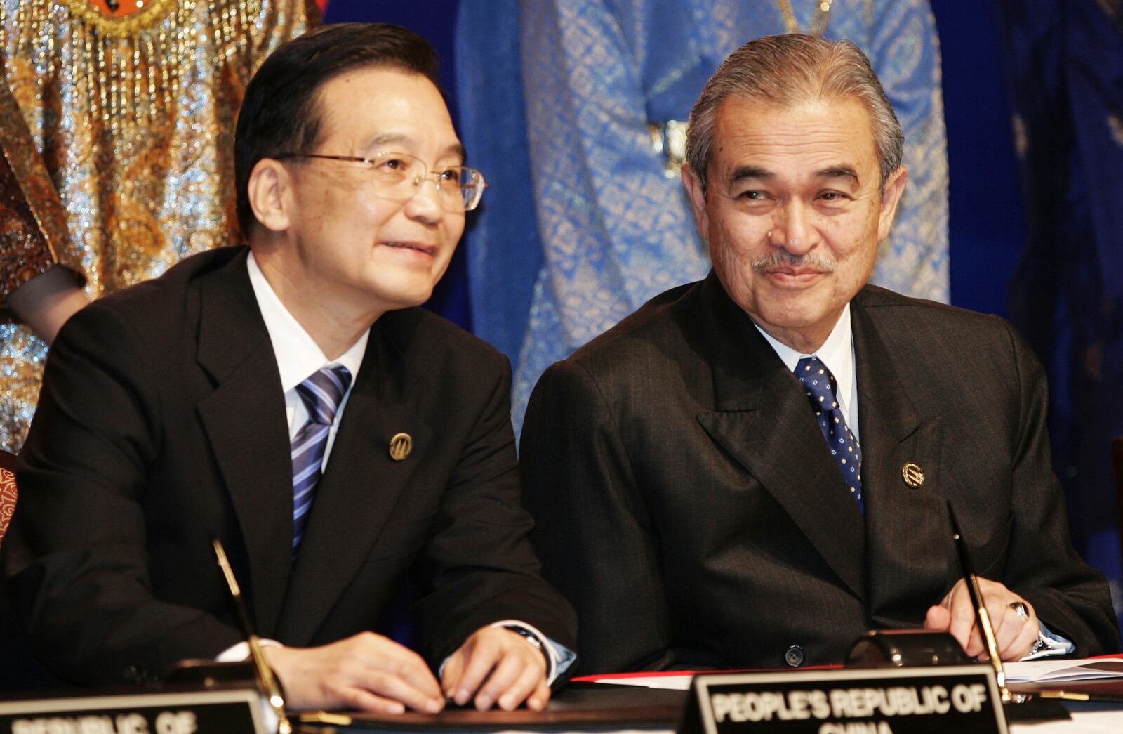 FILE - Chinese Prime Minister Wen Jiabao, left, sits next to Malaysia's Prime Minister Adbullah Ahmad Badawi during the Kuala Lumpur Declaration on the ASEAN+3 Summit at the Kuala Lumpur Convention Center in Kuala Lumpur, Malaysia, Monday, Dec. 12, 2005. (AP Photo/Vincent Thian, File)