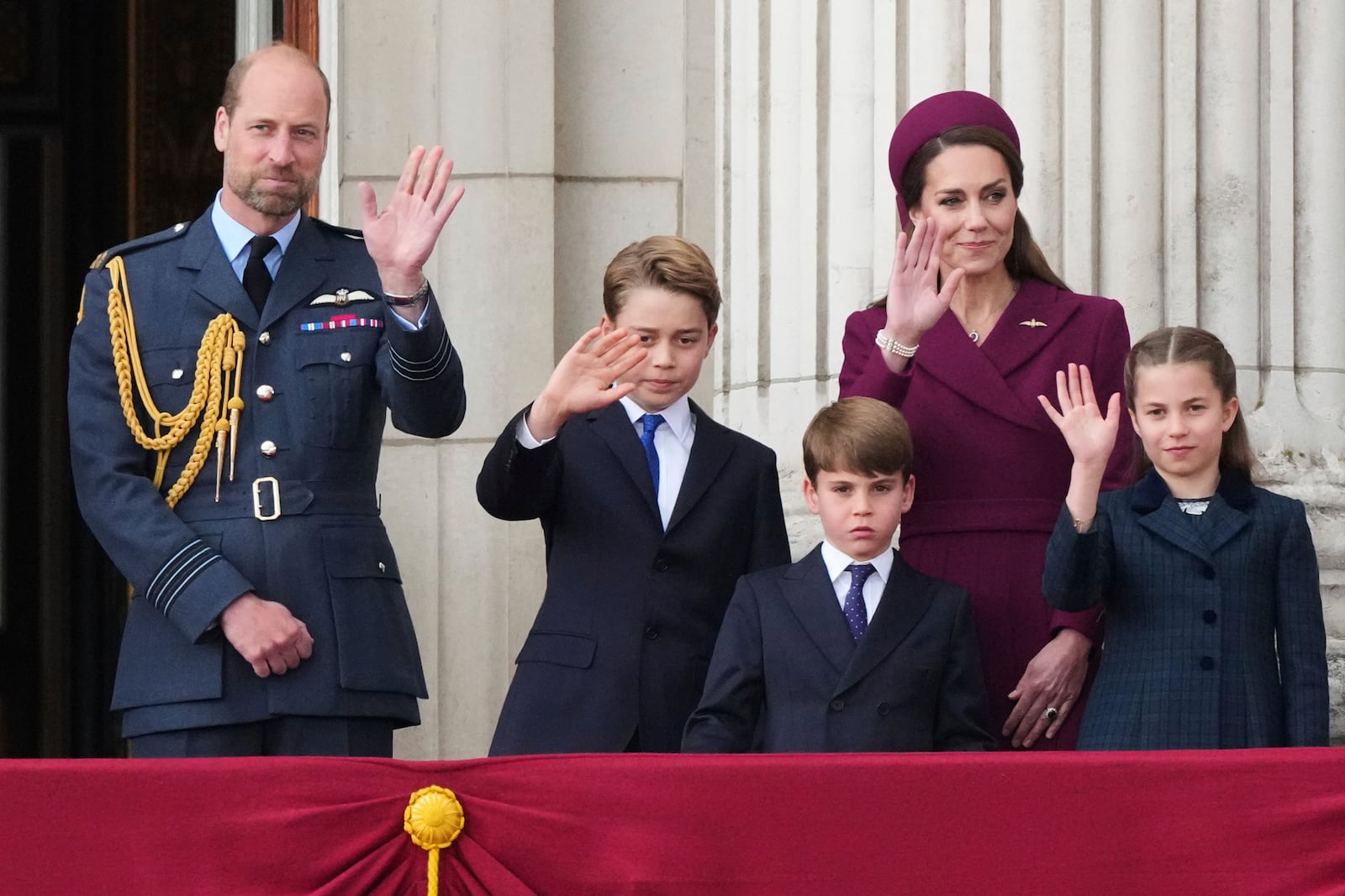 Britain's William, Prince of Wales, left, Prince George, second left, Prince Louis, center, Kate, Princess of Wales, second right, and Princess Charlotte, right, waves as they appear on the balcony of Buckingham Palace to watch the flypast during the V-E Day 80th anniversary parade in London, Monday, May 5, 2025. (AP Photo/Frank Augstein)