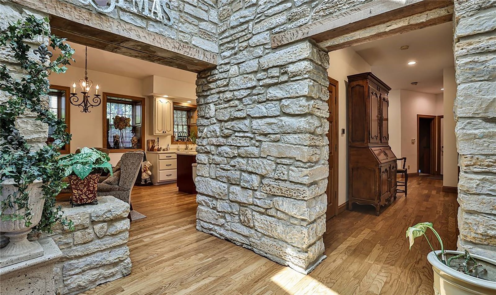 The home features limestone accent walls and fireplaces throughout.