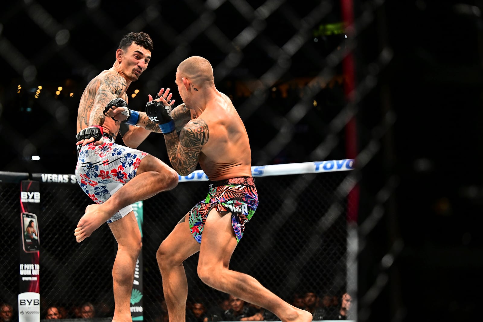 Dustin Poirier, right, fights against Max Holloway in a lightweight title fight at UFC 318 in New Orleans, La., Saturday, July 19, 2025. (AP Photo/Ella Hall)