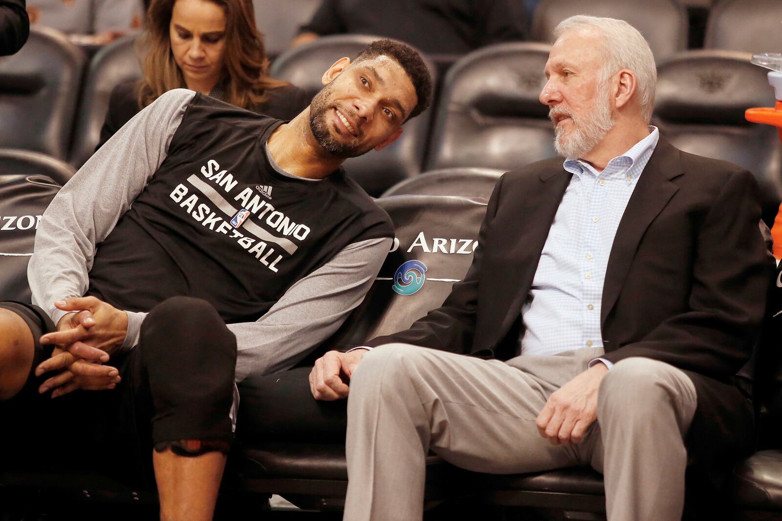 FILE - In this Feb. 28, 2015, file photo, San Antonio Spurs forward Tim Duncan, left, and head coach Gregg Popovich chat on the bench during the first quarter of an NBA basketball game against the Phoenix Suns in Phoenix. (AP Photo/Rick Scuteri, File)