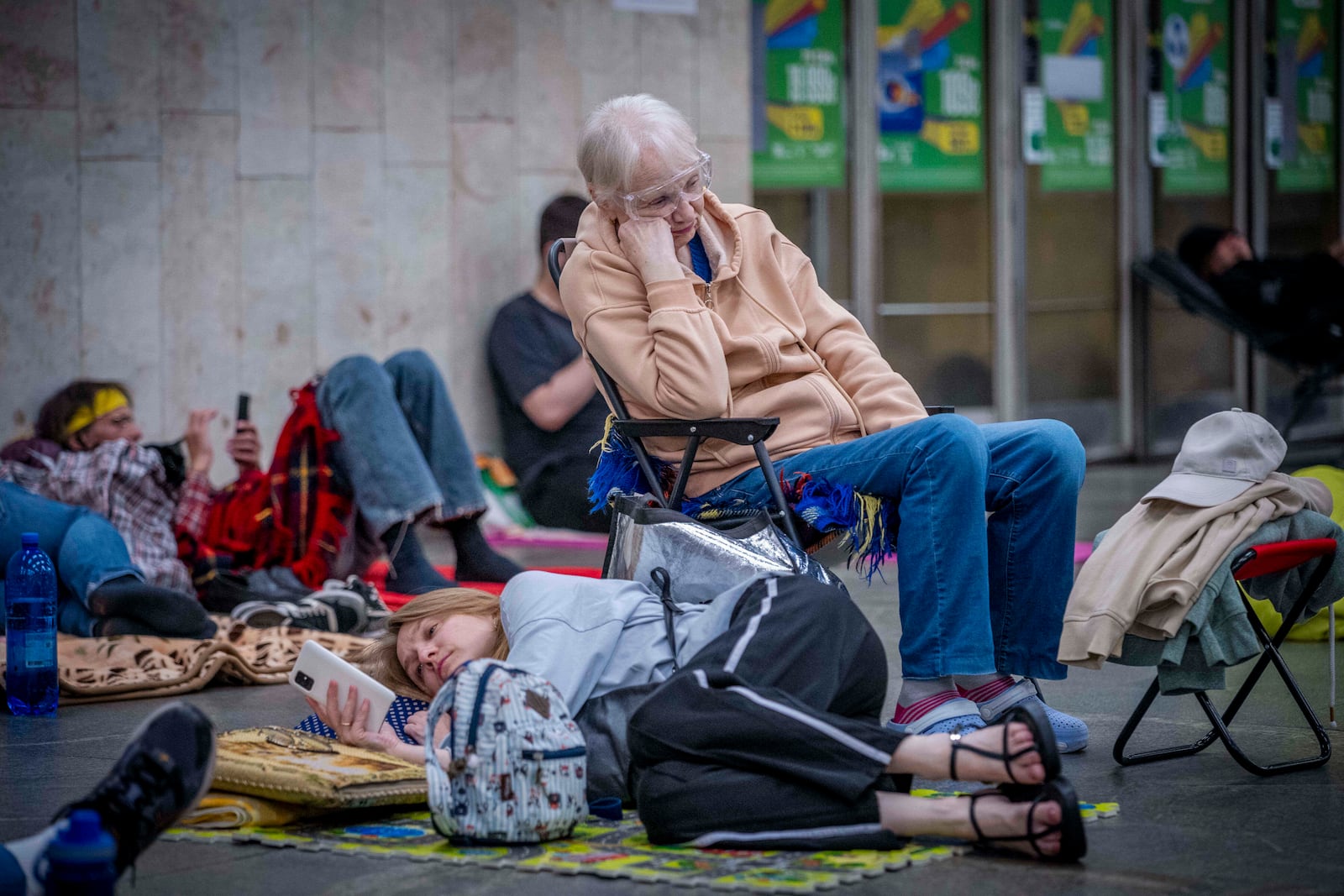 People hide in a metro station, being used as a bomb shelter, during a Russian drones attack in Kyiv, Ukraine, early hours Saturday, July 5, 2025. (AP Photo/Dan Bashakov)