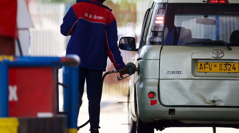 A service station worker fills a car's tank with gasoline in Harare, Thursday, March 5, 2026. (AP Photo/Wonder Mashura)