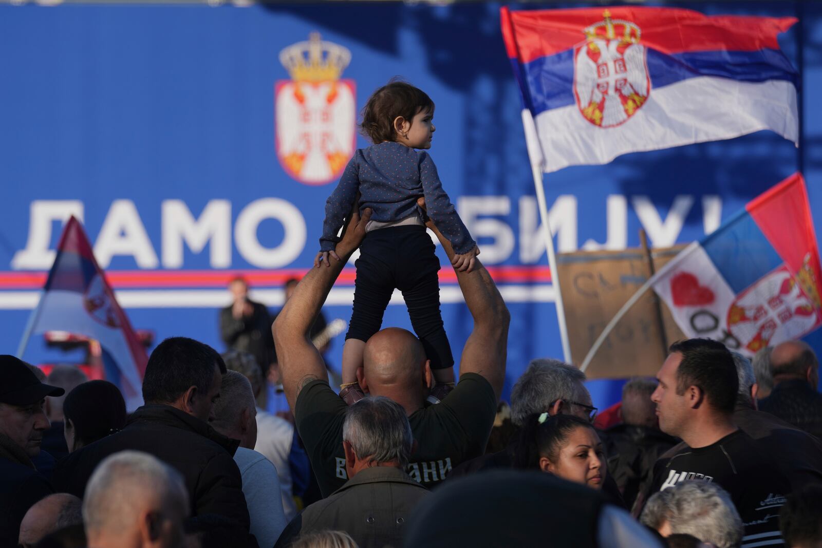 Supporters of Serbia's President Aleksandar Vucic gather during a rally, apparently designed to counter student-led gatherings, in Belgrade, Serbia, Saturday, April 12, 2025. (AP Photo/Darko Vojinovic)