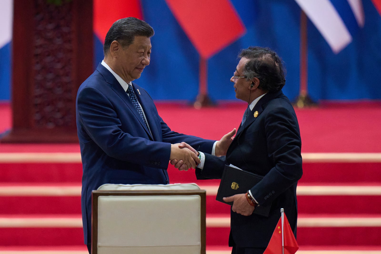 Chinese President Xi Jinping, left, shakes hands with Colombia's President Gustavo Petro after delivering his opening speech for the opening ceremony of the Fourth Ministerial Meeting of the Forum of China and Community of Latin American and Caribbean States at China National Convention Center in Beijing, Tuesday, May 13, 2025. (AP Photo/Andy Wong)