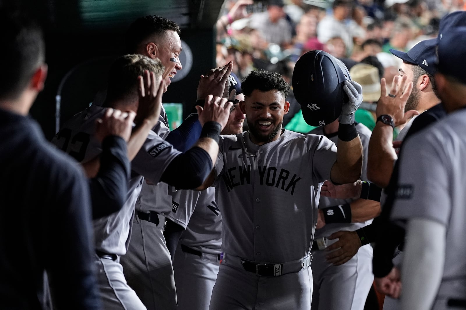 New York Yankees' Jasson Domínguez, center, celebrates with teammates in the dugout after hitting a solo home run during the seventh inning of a baseball game against the Athletics, Friday, May 9, 2025, in West Sacramento, Calif. (AP Photo/Godofredo A. Vásquez)