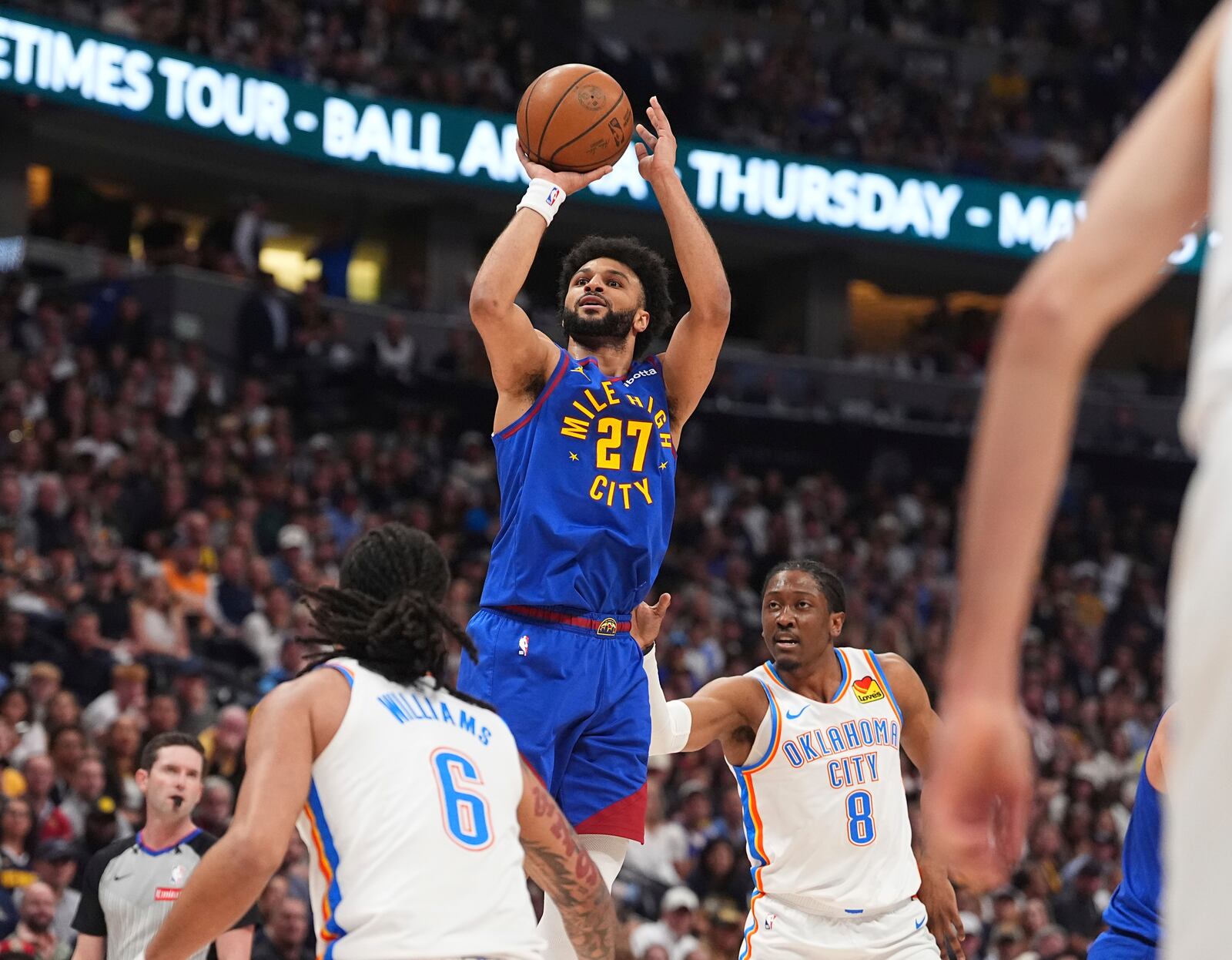 Denver Nuggets guard Jamal Murray (27) goes up for a basket between Oklahoma City Thunder forwards Jaylin Williams (6) and Jalen Williams (8) in the first half of Game 3 in the Western Conference semifinals of the NBA basketball playoffs Friday, May 9, 2025, in Denver. (AP Photo/David Zalubowski)