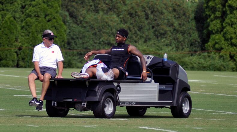 Cincinnati Bengals rookie running back Joe Mixon watches practice from a cart while icing his heel after getting kicked by a teammate during Thursday’s practice. JAY MORRISON/STAFF