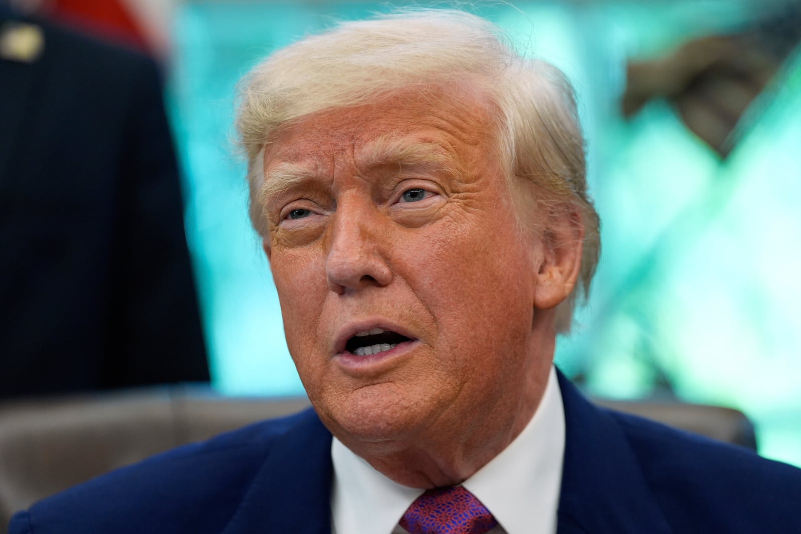 President Donald Trump speaks with reporters as he signs an executive order in the Oval Office of the White House, Friday, May 9, 2025, in Washington. (AP Photo/Alex Brandon)