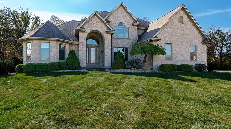 This brick two story features a finished basement and five full bedrooms and bathrooms.