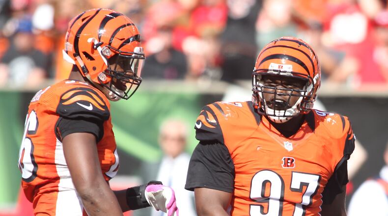 Bengals defensive tackle Geno Atkins, right, celebrates a sack with defensive end Carlos Dunlap against the Chiefs on Sunday, Oct. 4, 2015, at Paul Brown Stadium in Cincinnati. David Jablonski/Staff