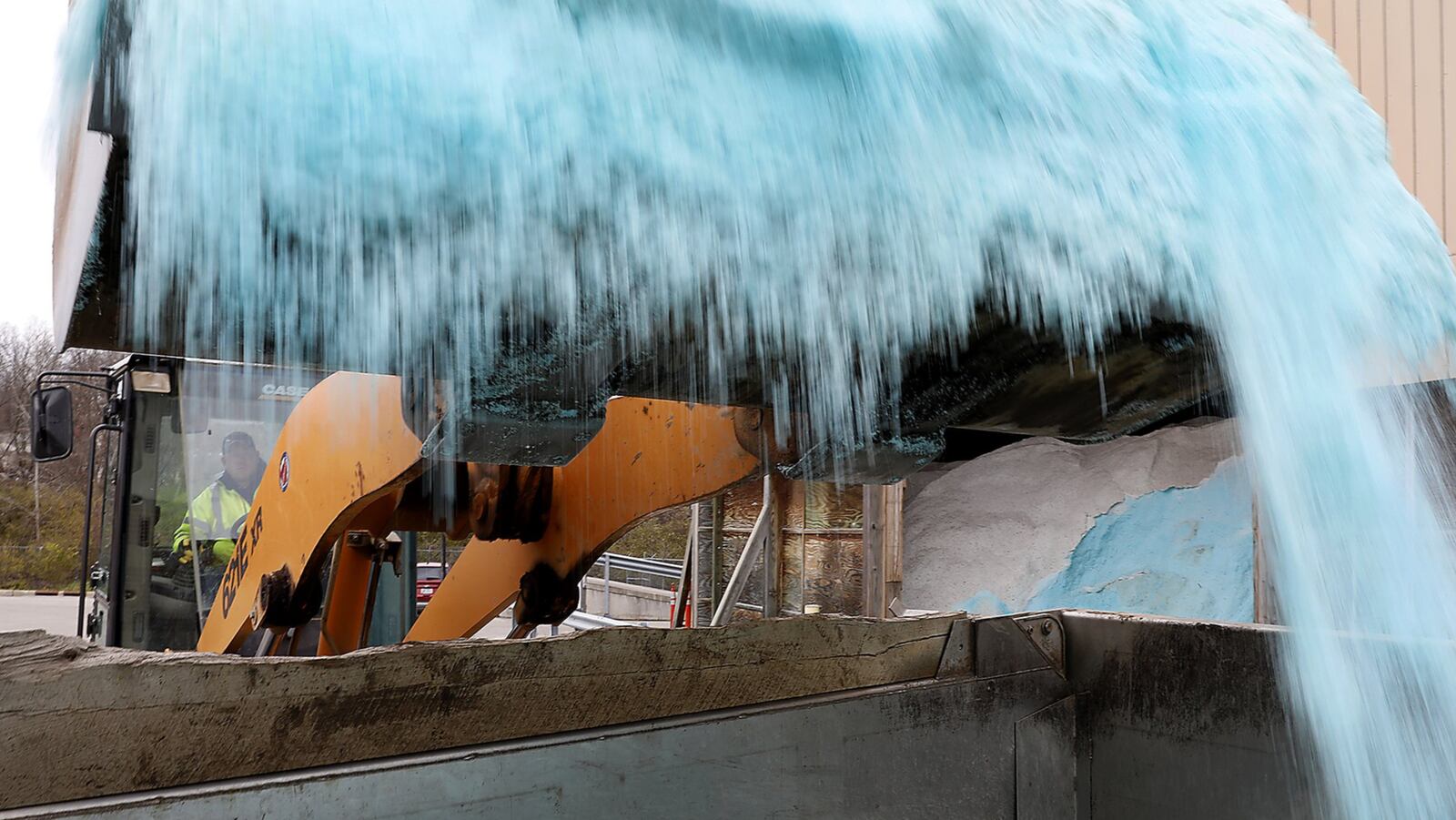 A City of Springfield worker fills up a plow truck with salt Thursday at the City Service Center in preparation for the snow expected this weekend. Bill Lackey/Staff
