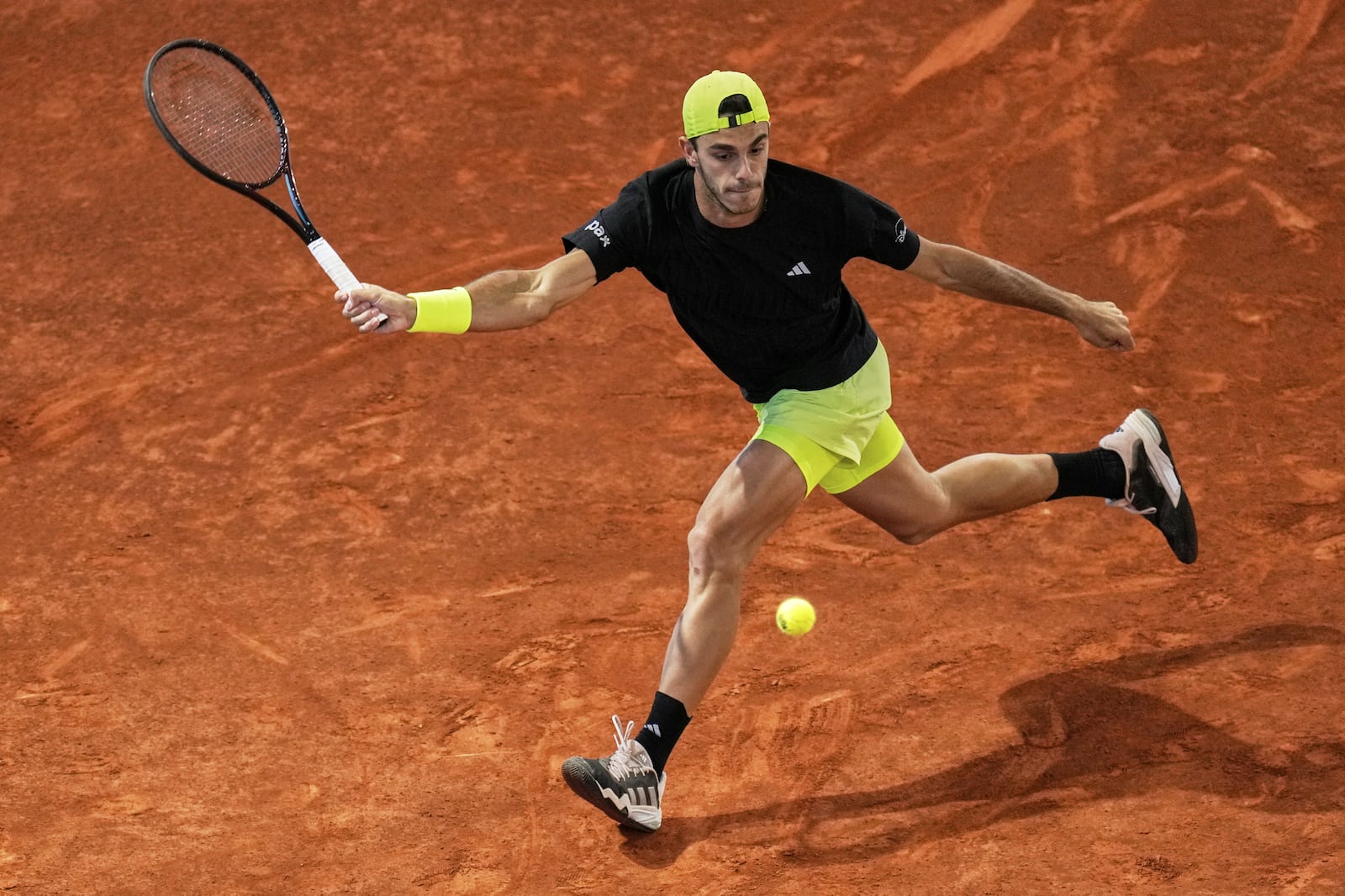 Francisco Cerundolo from Argentina returns the ball against Casper Ruud of Norway during men's semifinal at the Madrid Open tennis tournament in Madrid, Spain, Friday, May 2, 2025. (AP Photo/Manu Fernandez)