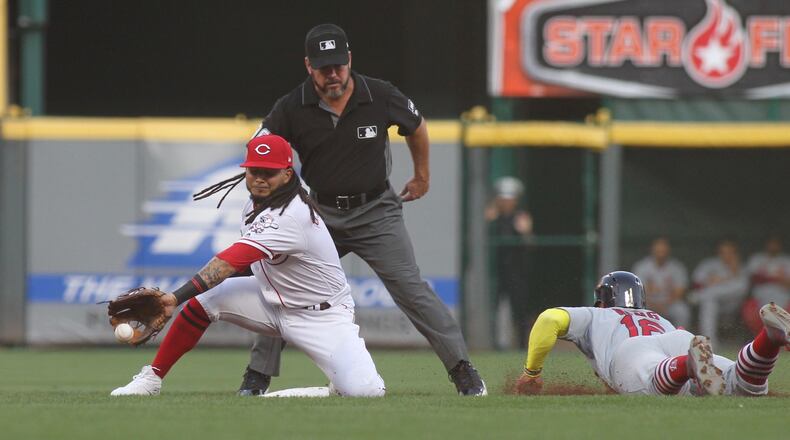 Reds second baseman Freddy Galvis takes a throw as the Cardinals’ Kolten Wong steals second base on Thursday, Aug. 15, 2019, at Great American Ball Park in Cincinnati. David Jablonski/Staff