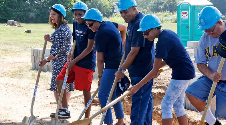 The Pringle family participates in a ground-breaking ceremony for their new Habitat for Humanity house in New Carlisle on Friday, August 4, 2023. BILL LACKEY/STAFF