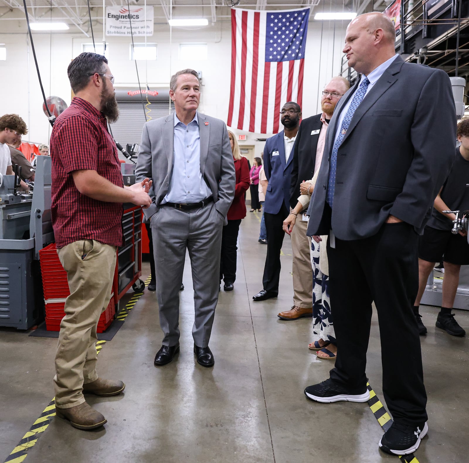 Sen. Jon Husted (center left) listens while David Curley (left) talks about what he teaches students at the school's career technology center on Friday, Sept. 5 in Riverside. Husted toured the school's CTC. BRYANT BILLING / STAFF