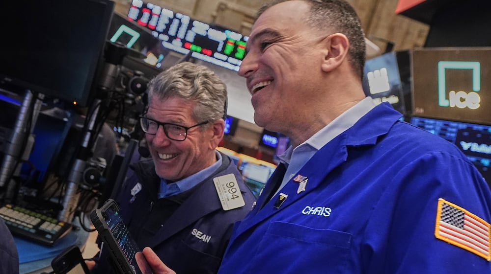 Traders Sean Spain, left, and Chris Lagana work on the floor of the New York Stock Exchange, Tuesday, Feb. 3, 2026. (AP Photo/Richard Drew)
