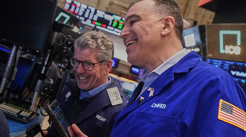 Traders Sean Spain, left, and Chris Lagana work on the floor of the New York Stock Exchange, Tuesday, Feb. 3, 2026. (AP Photo/Richard Drew)