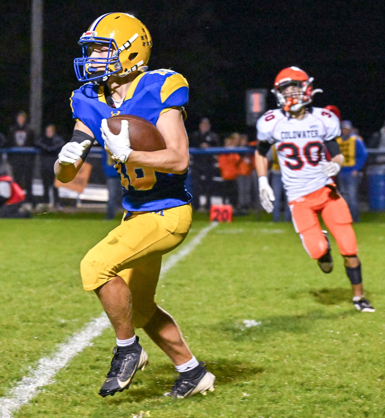Marion Local junior Andrew Schmackers runs during a 98-yard kickoff return for a touchdown late in the third quarter of a 7-6 win over Coldwater in a Midwest Athletic Conference game on Friday, Oct. 24 at Booster Stadium in Maria Stein. BRYANT BILLING/STAFF