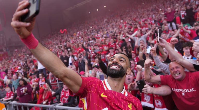 FILE - Liverpool's Mohamed Salah celebrates by taking a selfie after winning the English Premier League soccer match between Liverpool and Tottenham Hotspur and clinching the Premier League title at Anfield in Liverpool, England, April 27, 2025. (AP Photo/Jon Super, File)