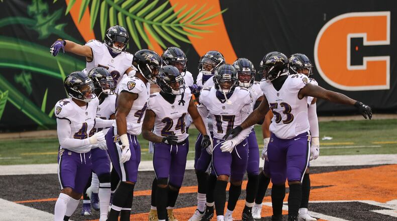 The Baltimore Ravens defense celebrates with cornerback Marcus Peters (24) after he intercepted a pass in the end zone intended for Cincinnati Bengals wide receiver A.J. Green during during the second half of an NFL football game, Sunday, Jan. 3, 2021, in Cincinnati. (AP Photo/Aaron Doster)