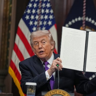 President Donald Trump holds up the Ratepayer Protection Pledge after signing it in the Indian Treaty Room of the Eisenhower Executive Office Building on the White House complex, Wednesday, March 4, 2026, in Washington. (AP Photo/Jacquelyn Martin)