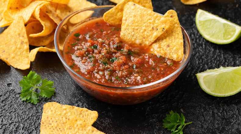 Mexican Tomato Salsa with lime, onion, jalapeno pepper, parsley and tortilla chips. ISTOCK