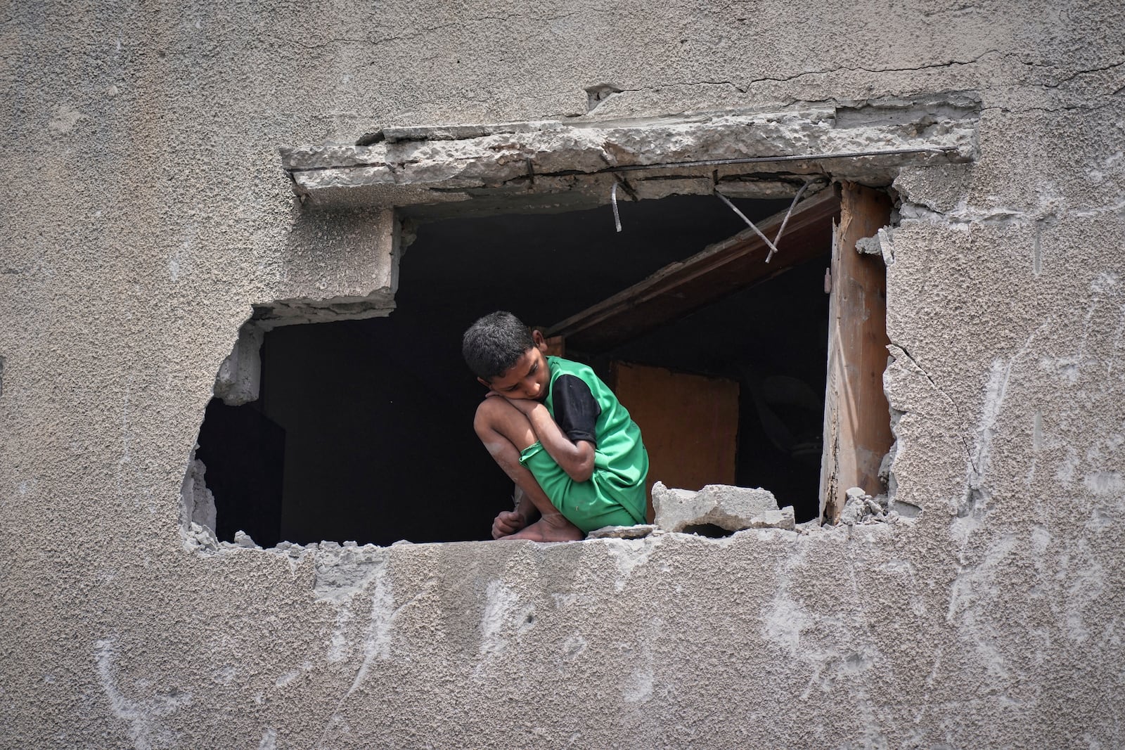 A boy looks as Palestinians search the rubble of a house targeted by an Israeli army strike that killed at least five people in Khan Younis, in the southern Gaza Strip, on Thursday, May 1, 2025. (AP Photo/Abdel Kareem Hana)