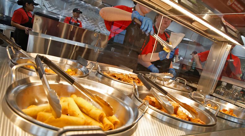 Panda Express has a fifth location planned for the Miami Valley, this time at the Mall at Fairfield Commons in Beavercreek. In this file photo, employees at the Springfield Panda Express serve customers on its opening day, Oct. 25, 2023. BILL LACKEY/STAFF