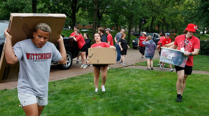 Wittenberg students and staff help incoming freshmen move there stuff into the dorms Thursday, August 24, 2023 during "Move-In Day" on campus. BILL LACKEY/STAFF