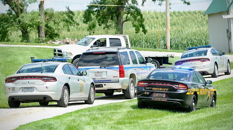 Officials responded to the scene of a helicopter crash in Clark County near Interstate 70 on Saturday, July 29, 2023. The helicopter, which was applying chemicals to farm crops, hit utility lines that fell across I-70, causing three accidents on the highway, and the helicopter pilot was pronounced dead after the craft crashed in a corn field nearby. MARSHALL GORBY/STAFF