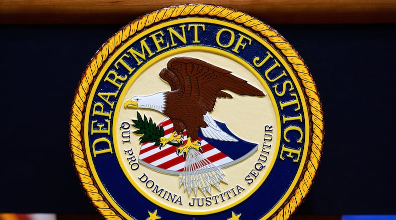 FILE - The U.S. Department of Justice logo is seen on a podium before a press conference, May 6, 2025, at the Justice Department in Washington. (AP Photo/Julia Demaree Nikhinson, File)