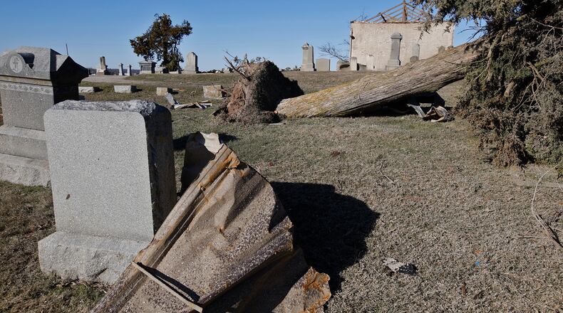 Grave markers and trees are toppled over in the Fletcher-Chapel Cemetery after Wednesday's tornado. BILL LACKEY/STAFF