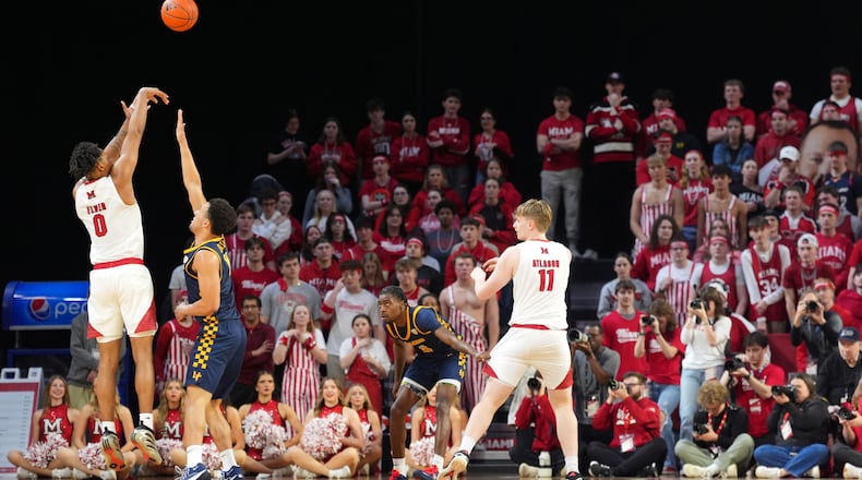 Miami's (OH) Eian Elmer, far left, shoots a 3-point basket during the first half of an NCAA college basketball game against Toledo, Tuesday, March 3, 2026, in Oxford, Ohio. (AP Photo/Kareem Elgazzar)
