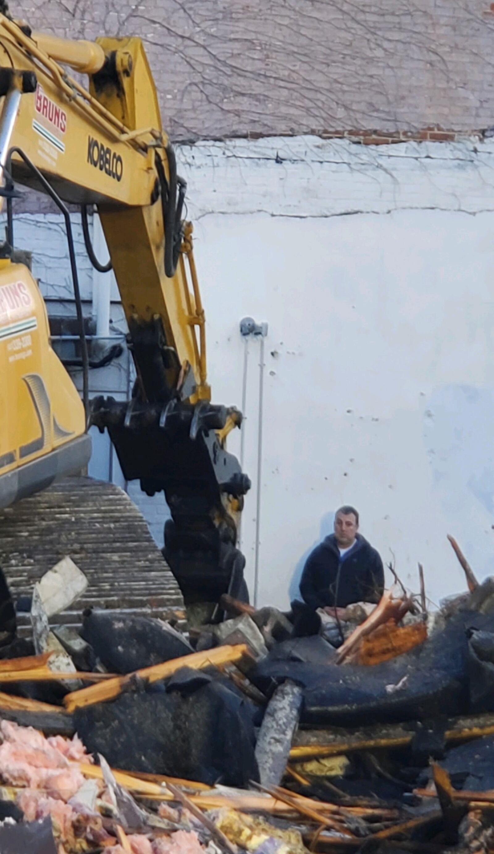 Troy Historic Preservation Alliance member Ben Sutherly stands in front of heavy equipment demolishing part of the Troy Tavern building on Wednesday morning, March 29, 2023. CONTRIBUTED PHOTO