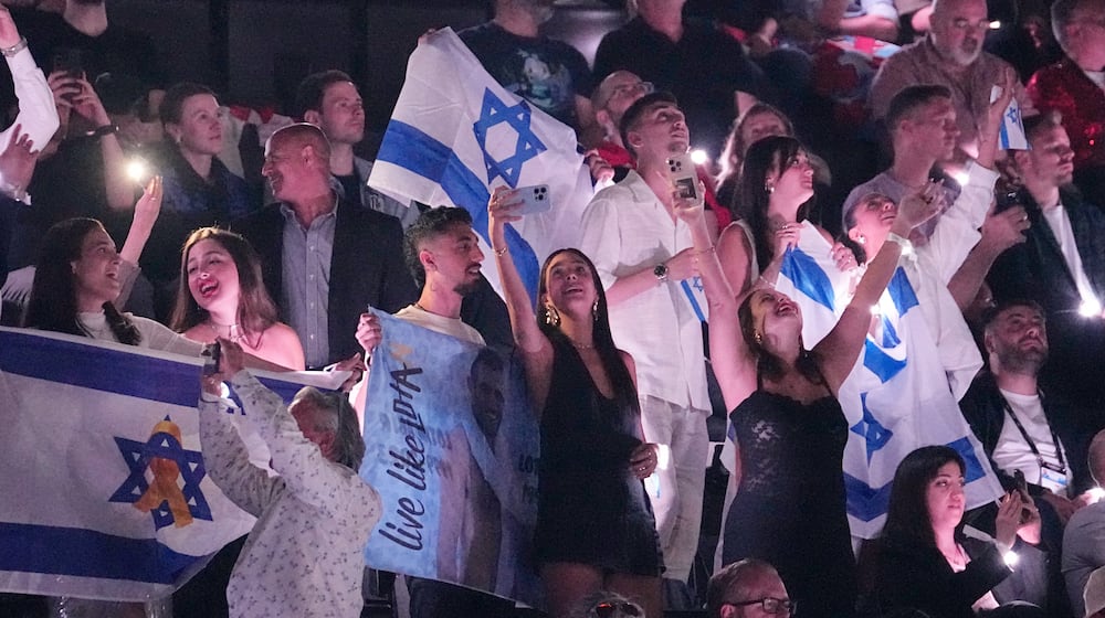 FILE - Israeli fans cheer for Yuval Raphael from Israel after performing during the Semi-Final of the 69th Eurovision Song Contest, in Basel, Switzerland, Thursday, May 15, 2025. (AP Photo/Martin Meissner, File)