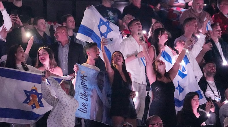 FILE - Israeli fans cheer for Yuval Raphael from Israel after performing during the Semi-Final of the 69th Eurovision Song Contest, in Basel, Switzerland, Thursday, May 15, 2025. (AP Photo/Martin Meissner, File)
