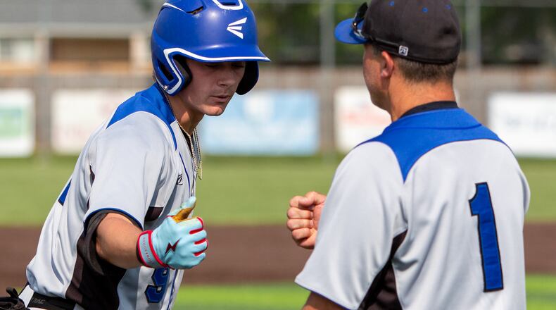 Springboro's A.J. Ewing celebrates with head coach Mark Pelfrey after hitting a triple in the first inning Tuesday at Vandalia Butler. Jeff Gilbert/CONTRIB
UTED