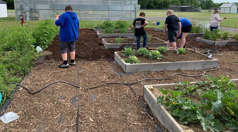 Graham Middle/High School FLIGHT program students working in the garden. CONTRIBUTED