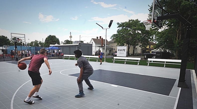 Nearly 100 people attended the dedication and ribbon-cutting of the new H.O.P.E. Basketball court on Linden Ave. MARSHALL GORBYSTAFF