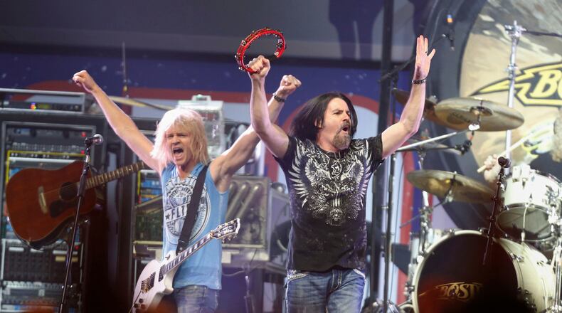 FILE - Tommy DeCarlo, lead singer of the group Boston, right, performs at the Boston Strong Concert: An Evening of Support and Celebration at the TD Garden, Thursday, May 30, 2013, in Boston. (Photo by Bizuayehu Tesfaye/Invision/AP, File)